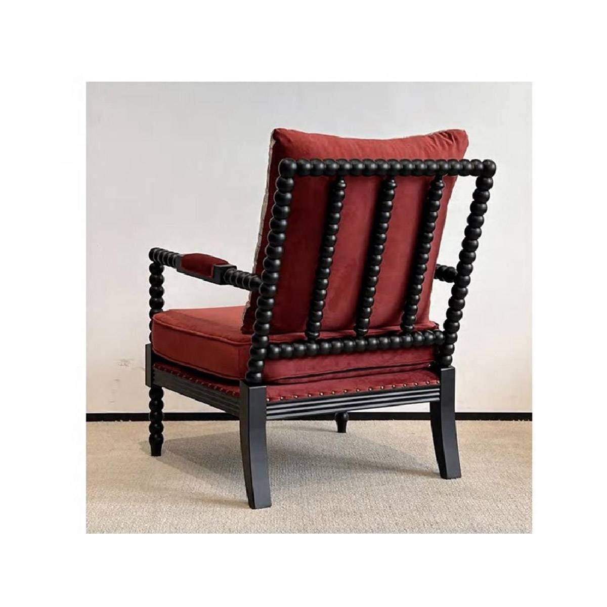 Rear view showing the beaded backrest structure and red velvet cushion