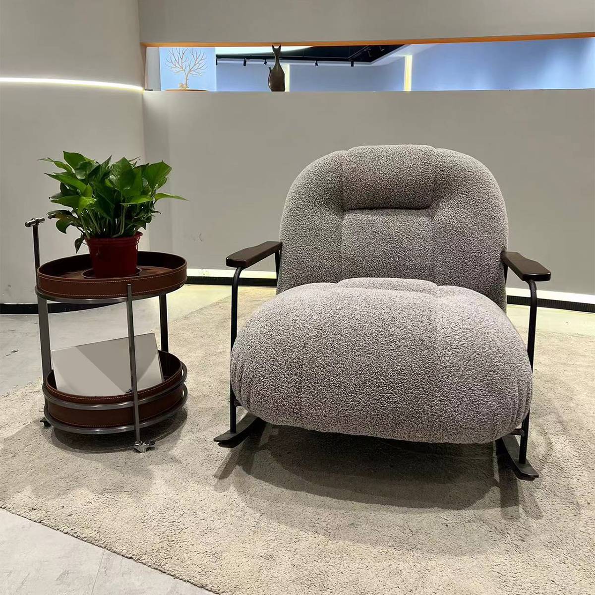 Front view of a grey fabric rocking lounge chair
