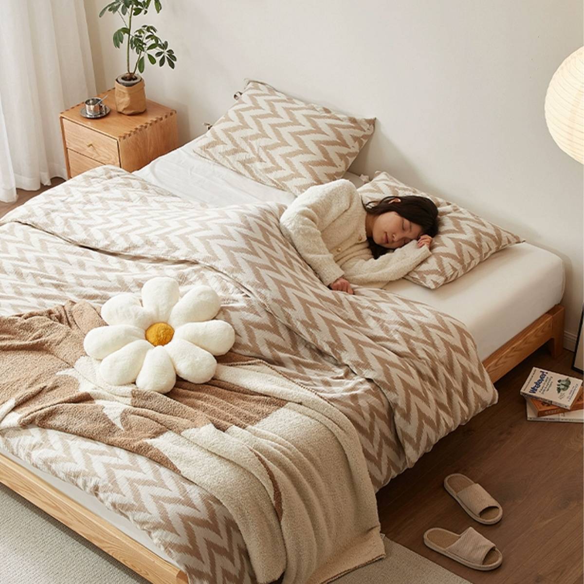 High angle view of the bed with a person sleeping, demonstrating the scale and comfort.