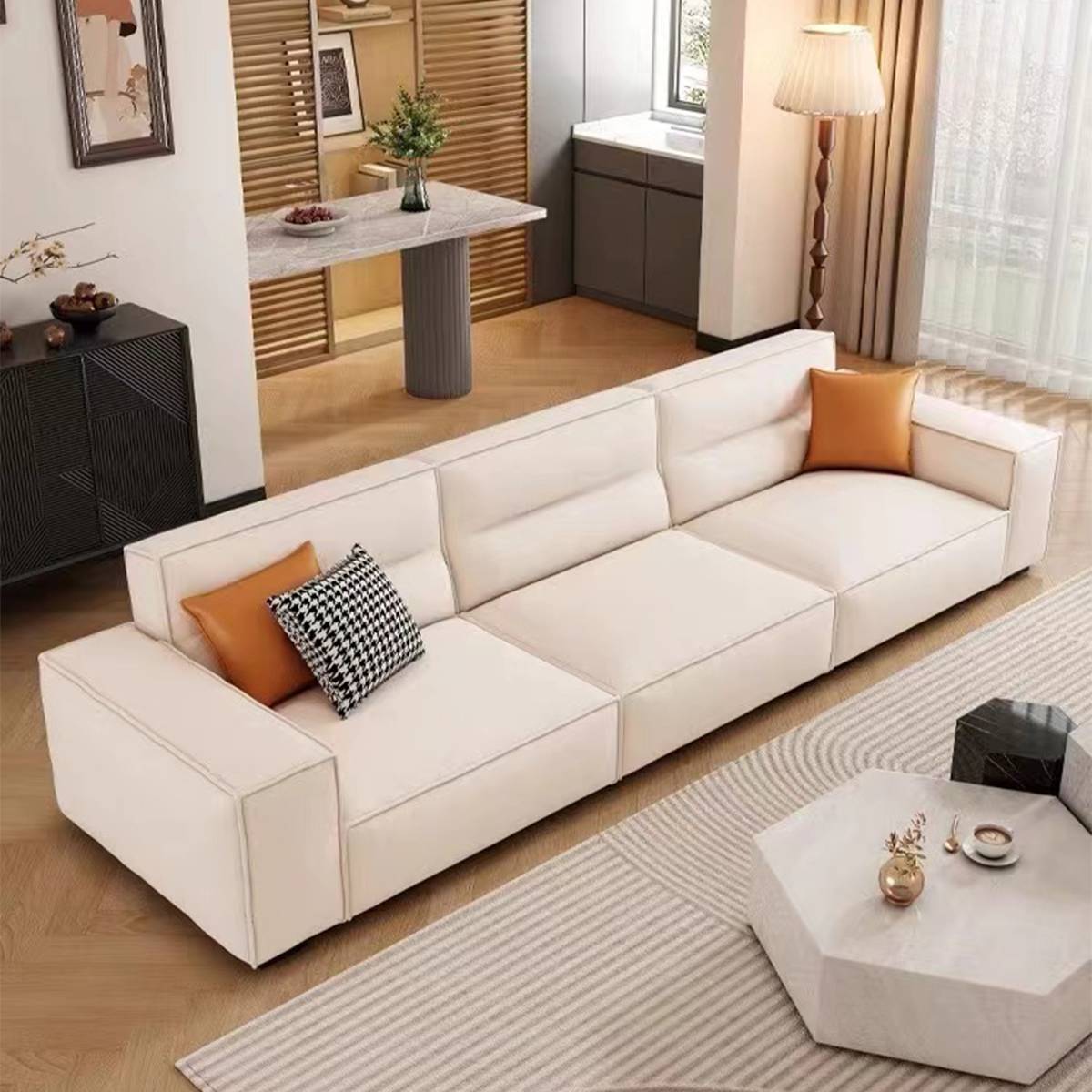 Side angle view of the sofa in a bright living room with a hexagonal coffee table.