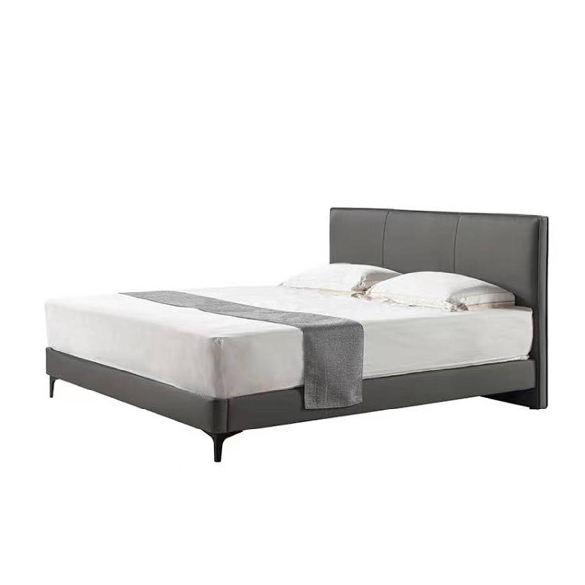 Side angle view of the grey upholstered bed showing the headboard and frame
