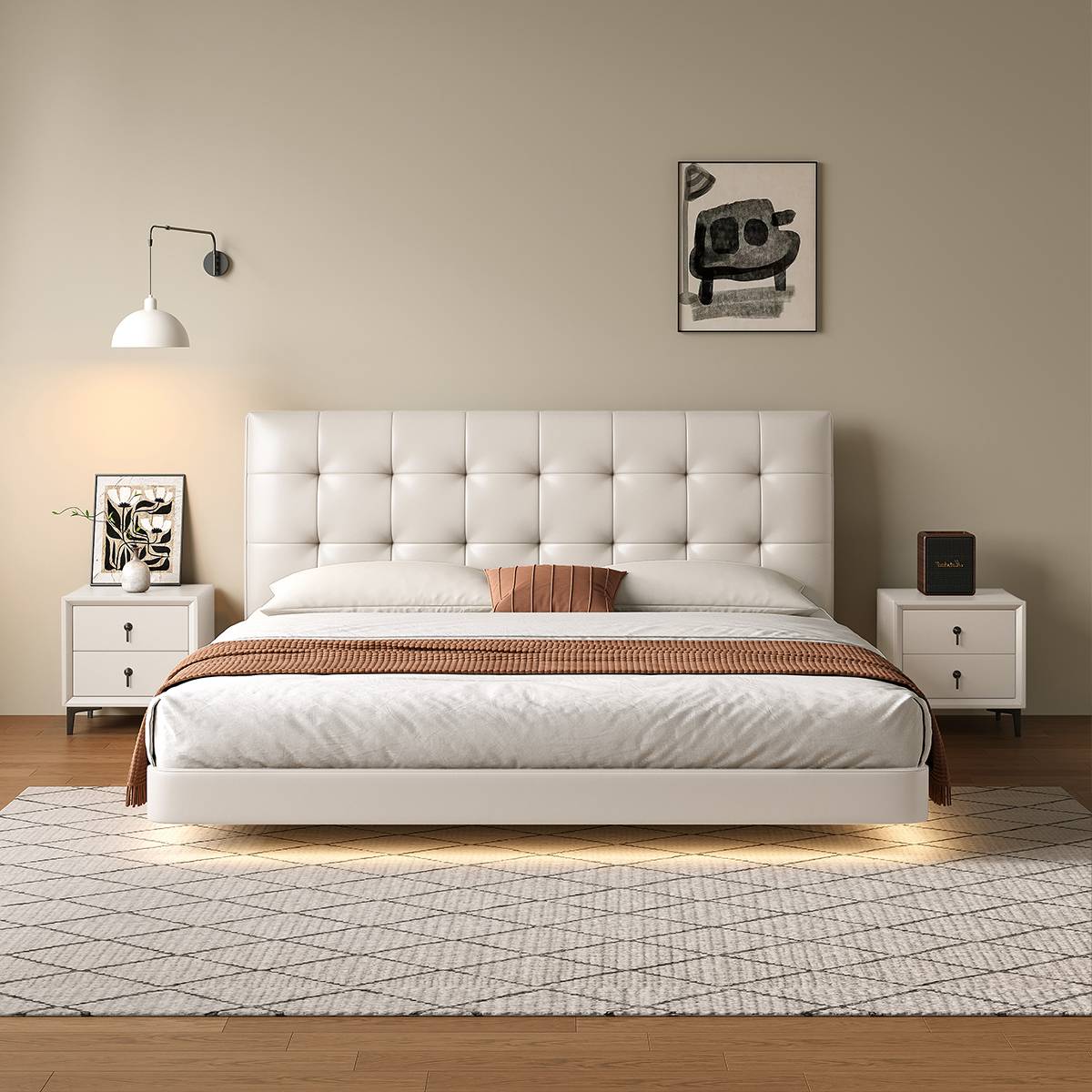 White eco-leather tufted bed with matching white bedside tables