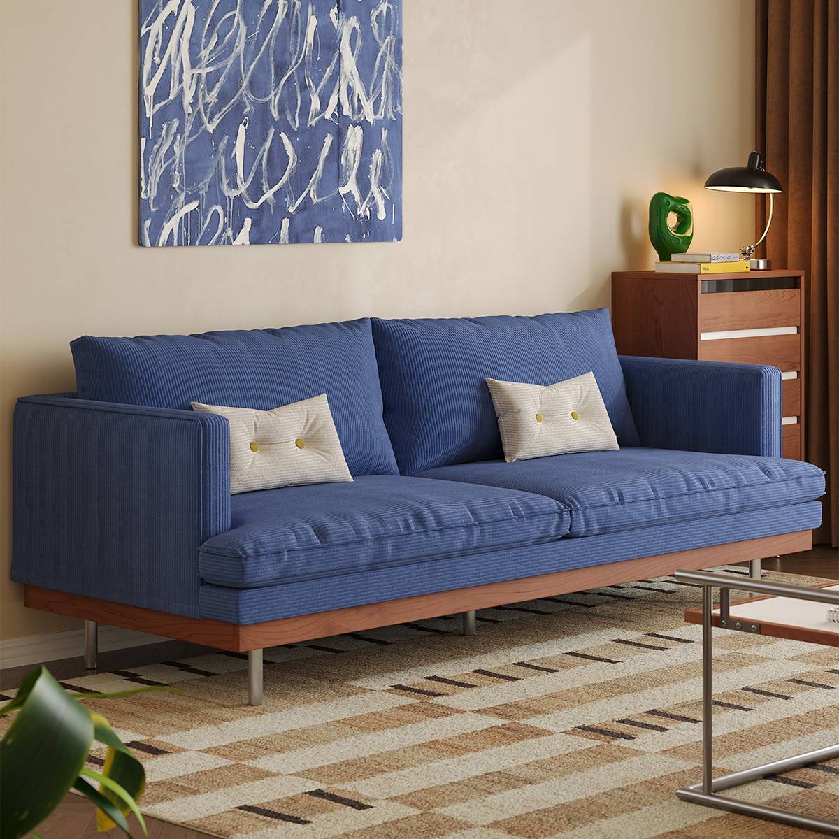 Klein blue corduroy sofa with white pillows