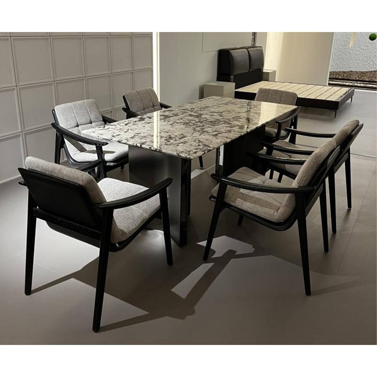 Wide shot of the dining table set in a showroom environment