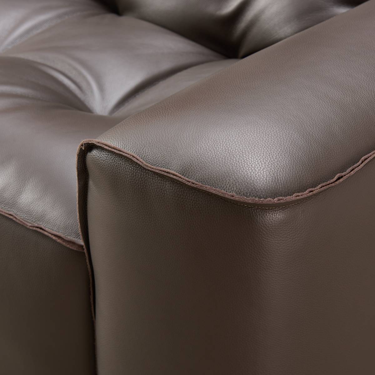 Detail shot of the leather armrest edge and stitching
