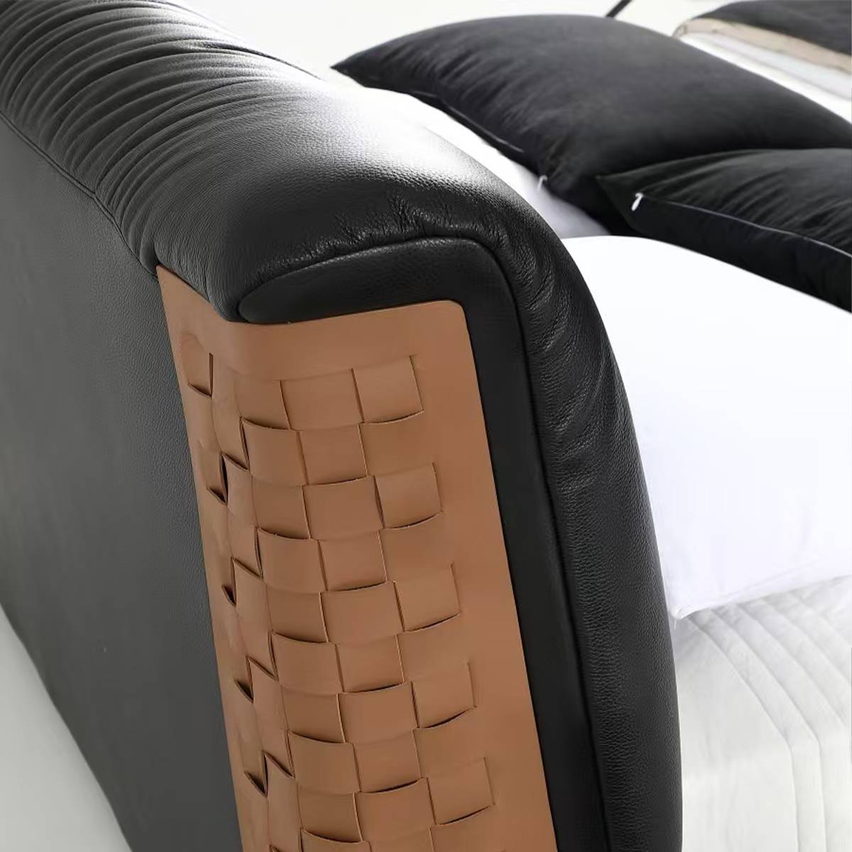 Detail shot of the black leather texture and stitching on the headboard