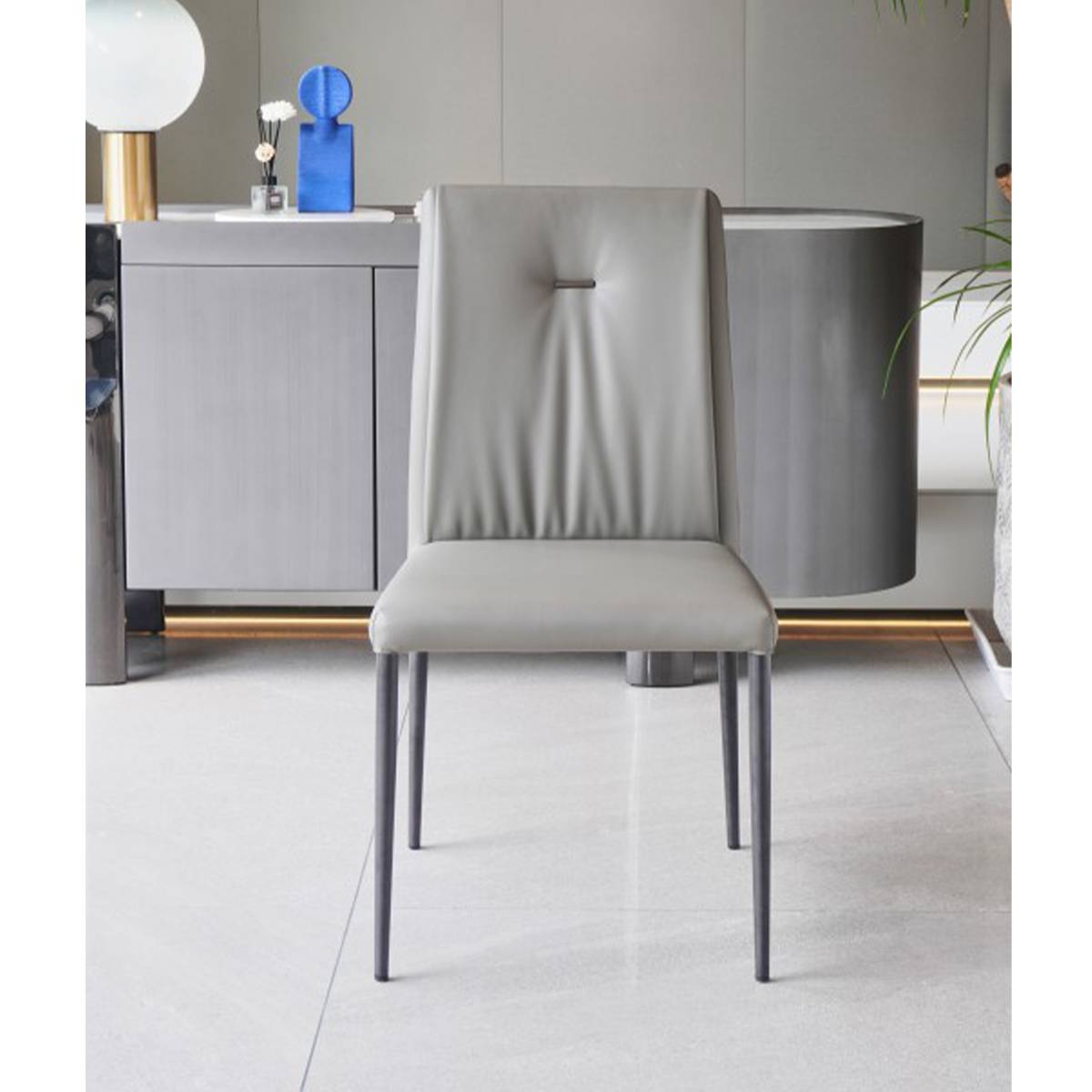 Front view of the grey dining chair showing the tufted backrest