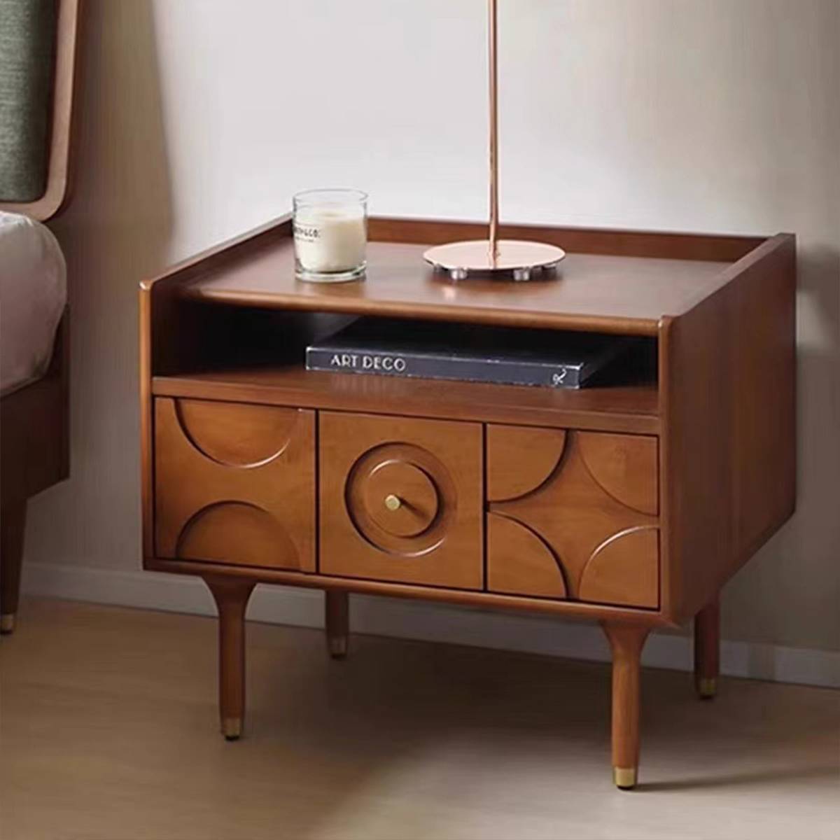 Front view of the wooden nightstand next to a bed