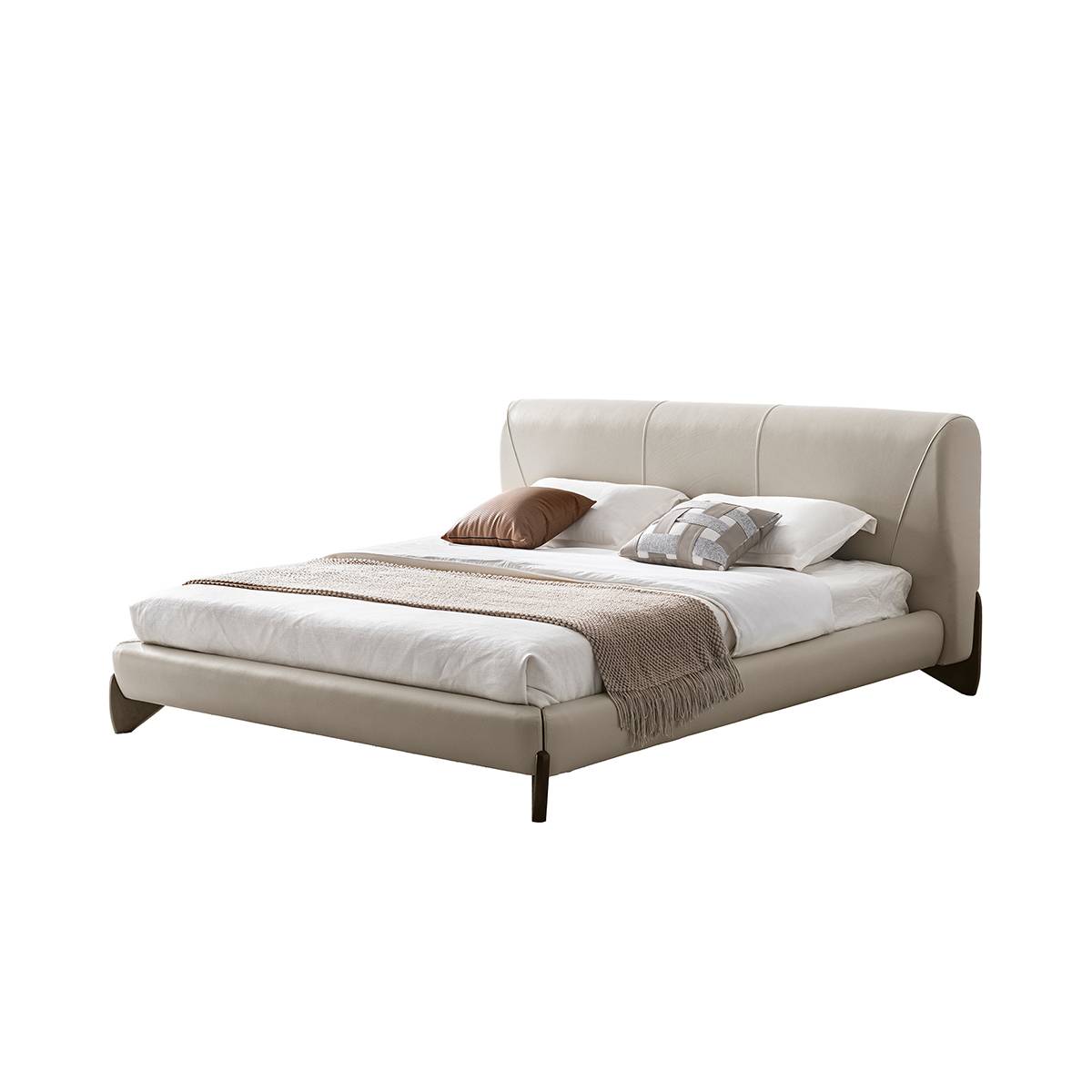 Three-quarter view of the beige leather bed against a white background