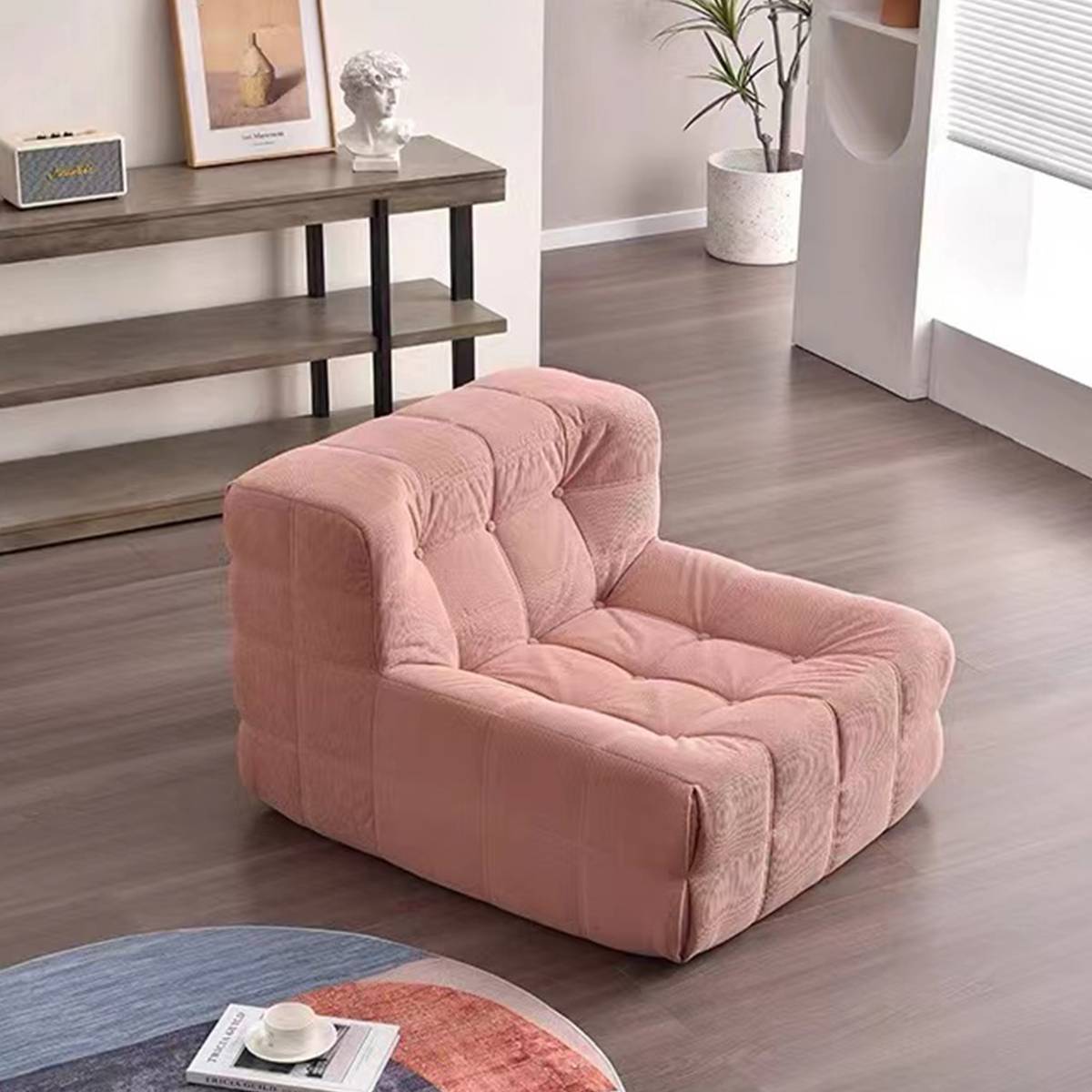 Pink waffle grid lounge chair placed on a wooden floor