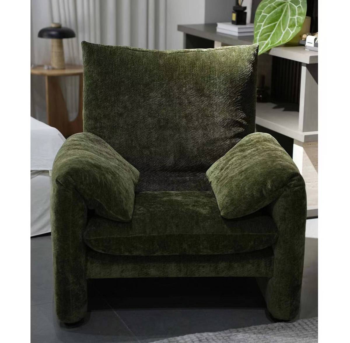Front view of green velvet lounge chair in a room setting