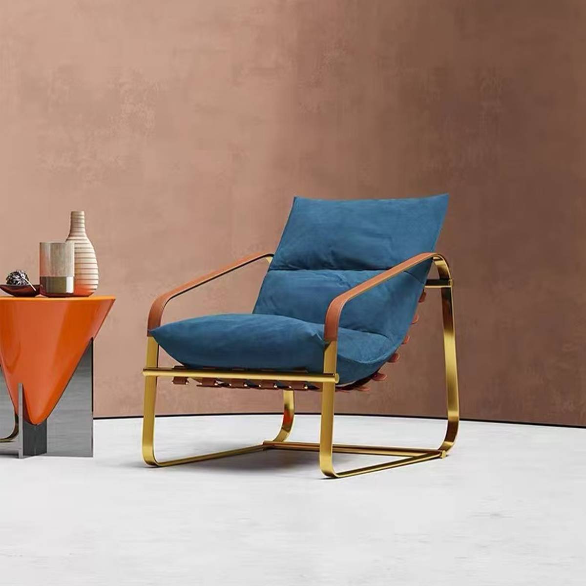 Blue velvet lounge chair with gold metal frame