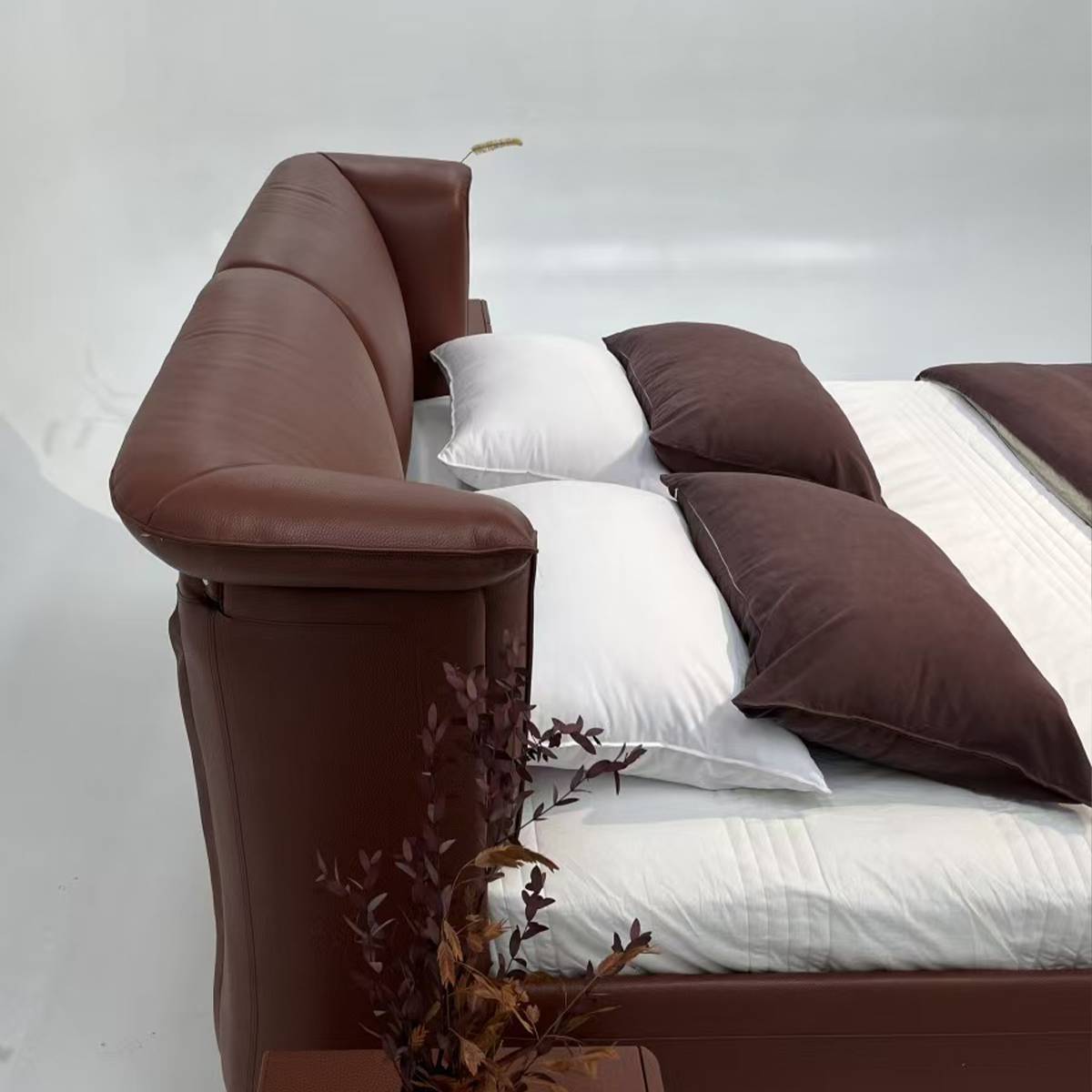Side view of brown leather bed headboard and frame