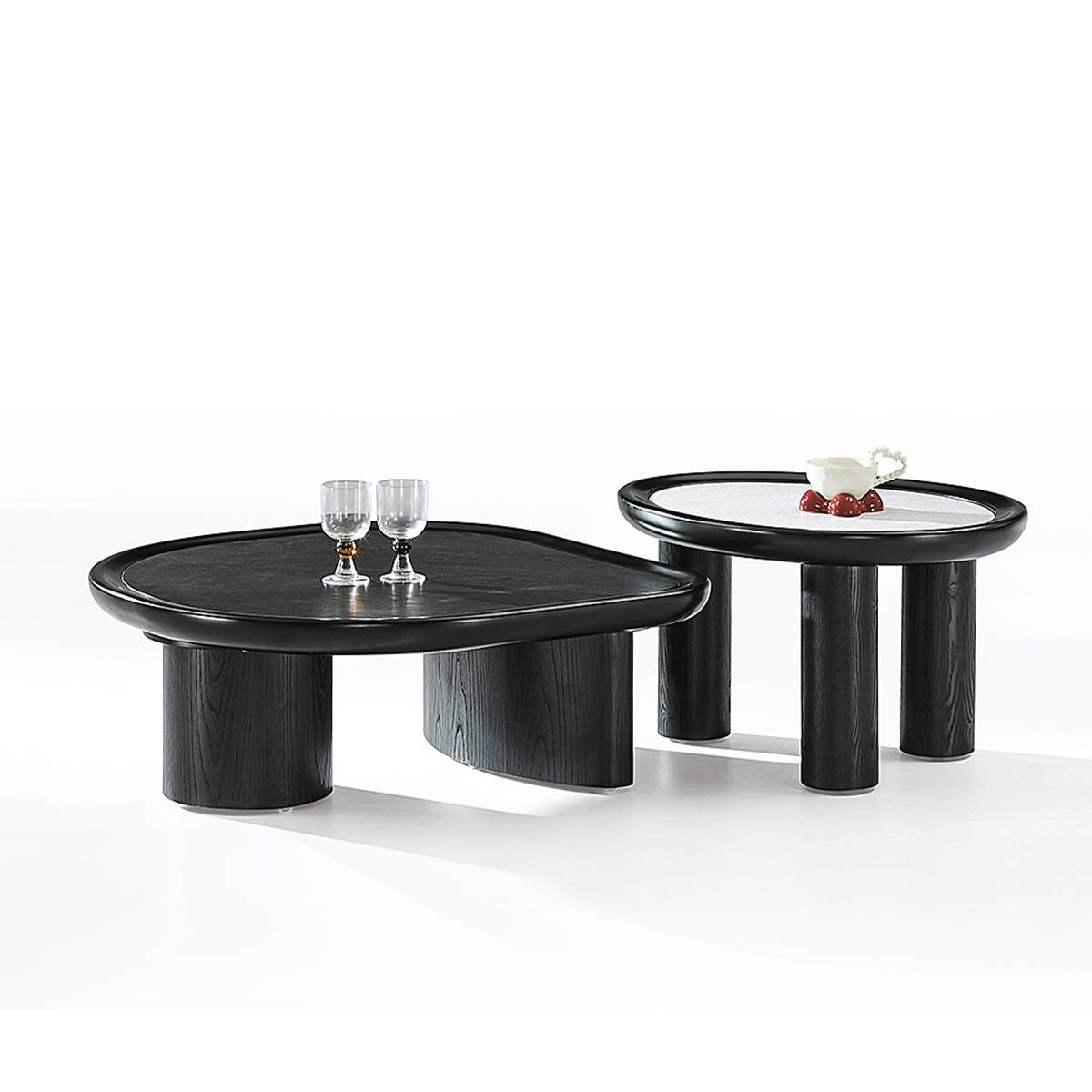 Side view of the modern coffee table set showing the cylindrical legs and contrasting surfaces