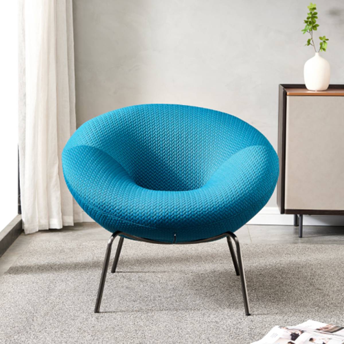 Front view of a blue knitted fabric lounge chair with stainless steel legs