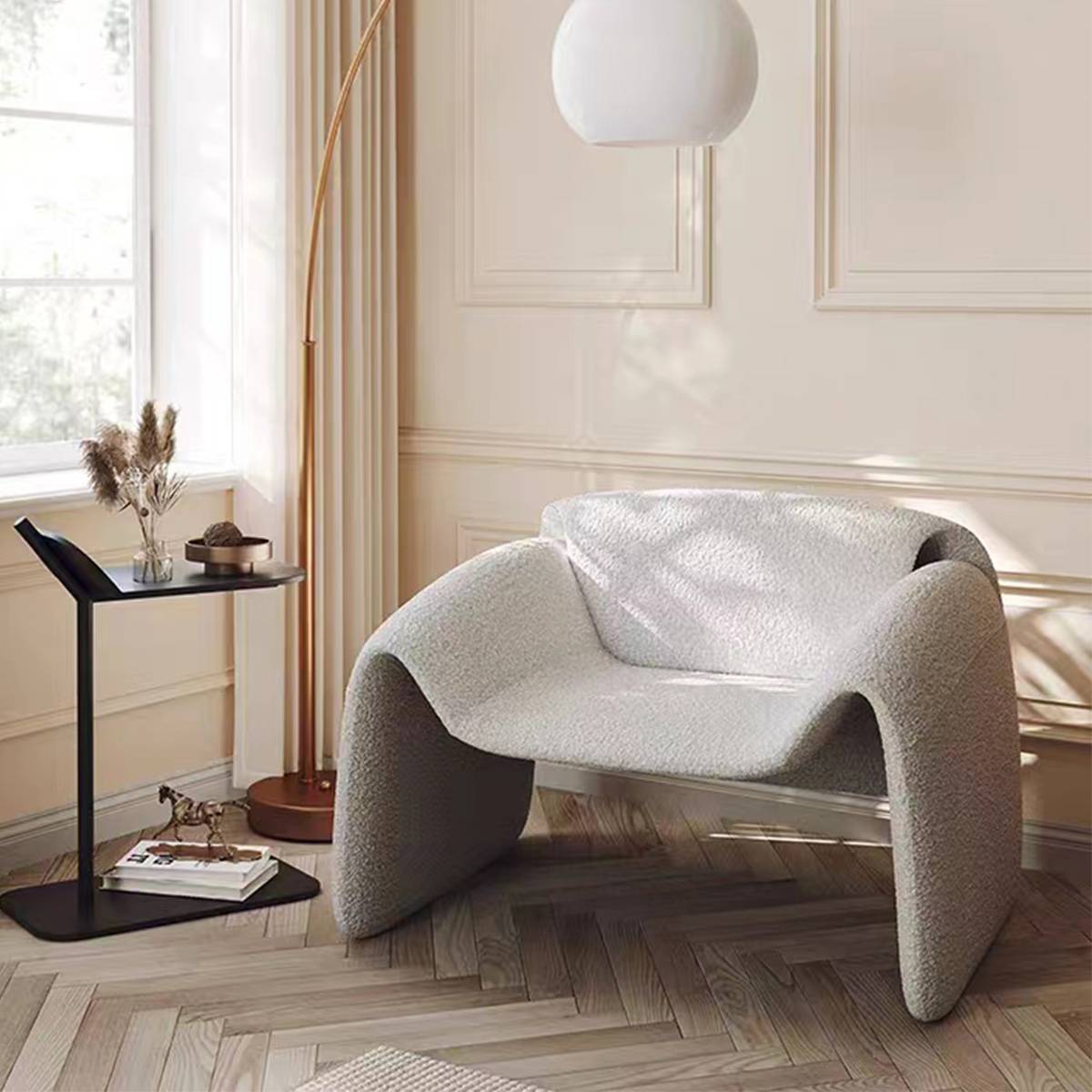 White boucle fabric Crab Lounge Chair in bright room