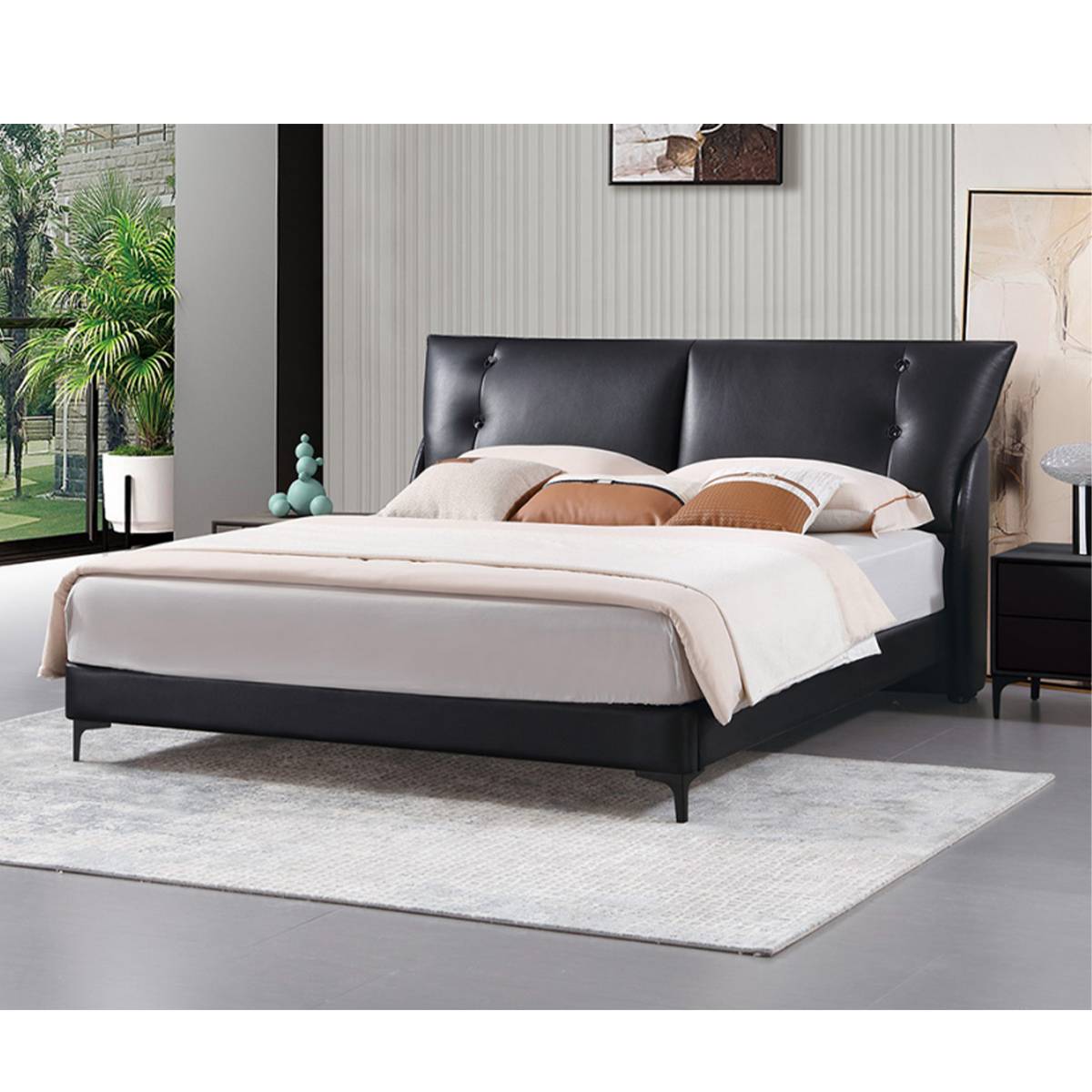 Alternative angle of the black leather bed showing the headboard and bedding