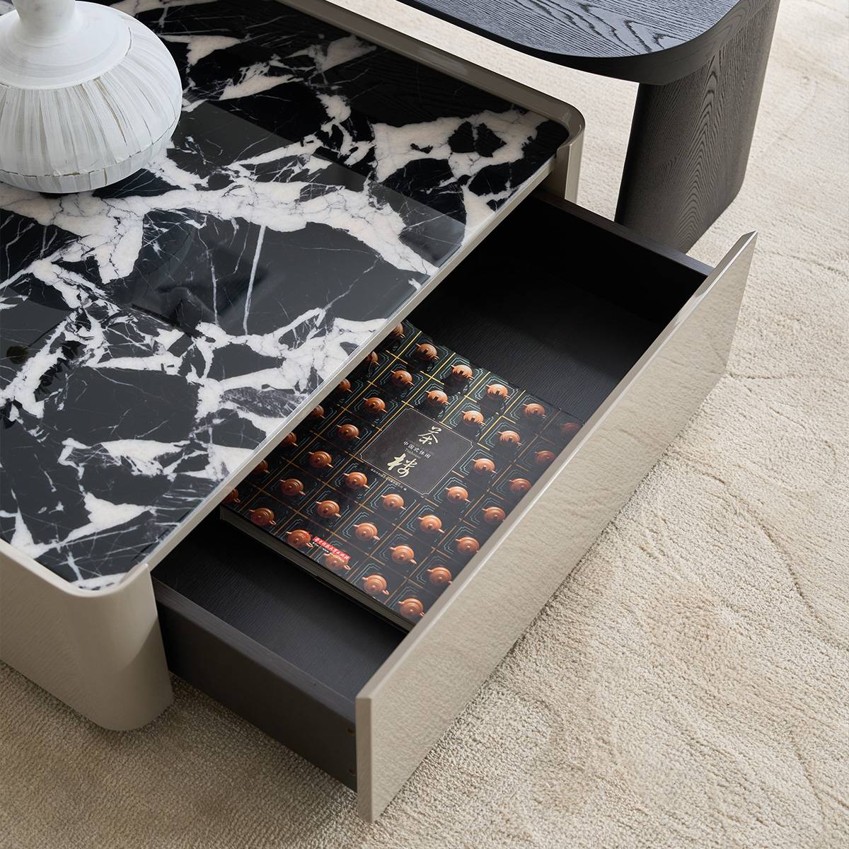 Close-up of the coffee table drawer open, revealing storage space