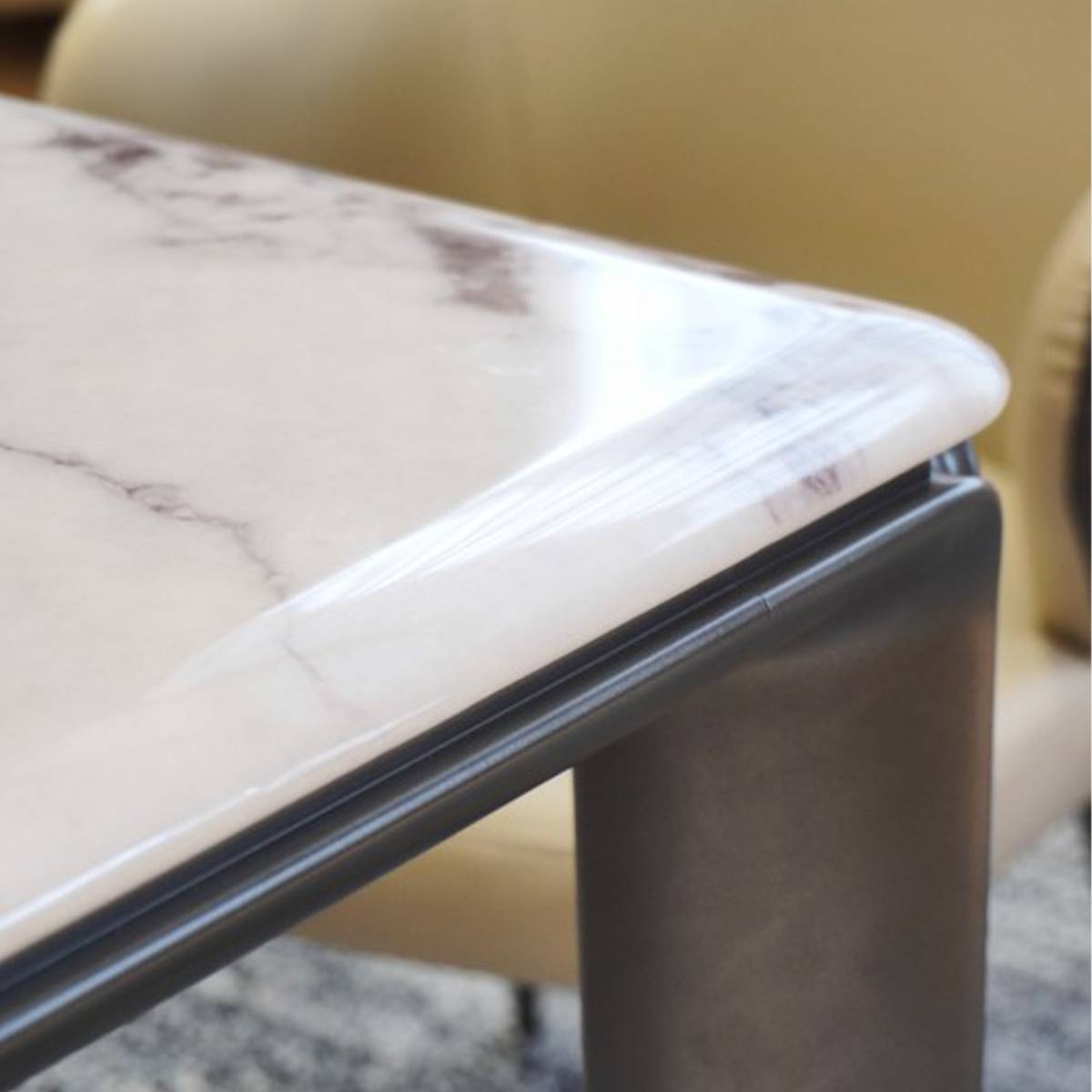Close-up detail of the dining table corner showing the polished microcrystalline stone edge and aluminum alloy leg connection