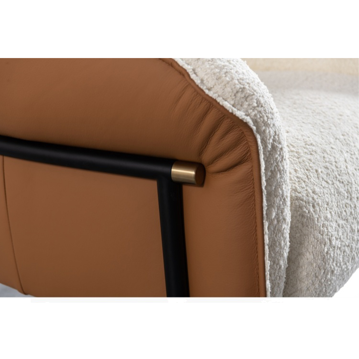 Close-up of the lounge chair showing the brown leather and sheepskin texture