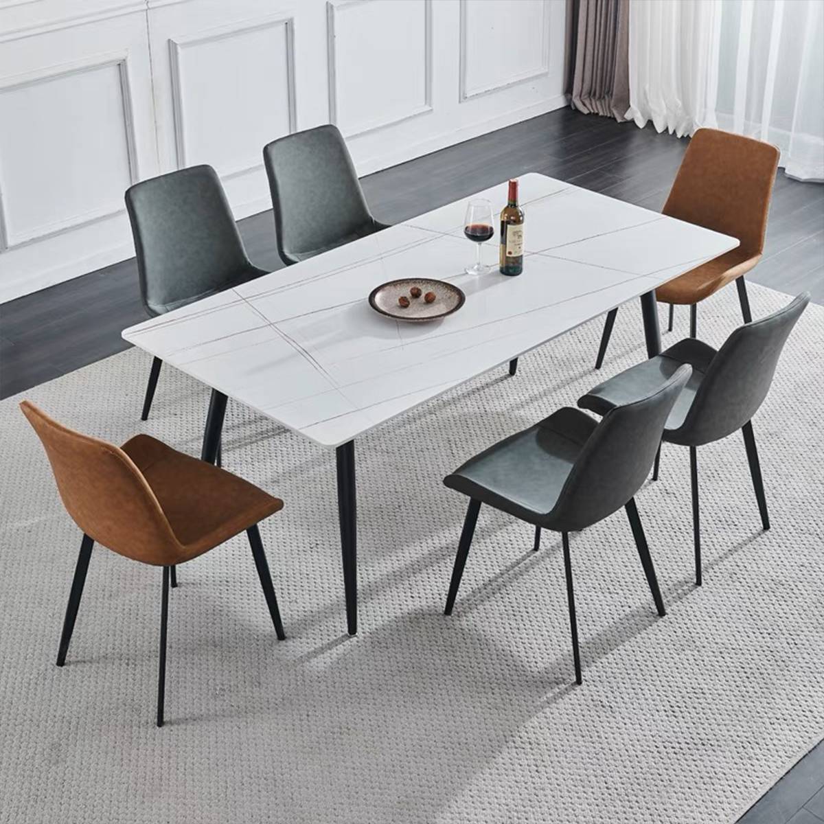 White sintered stone dining table with grey and brown chairs