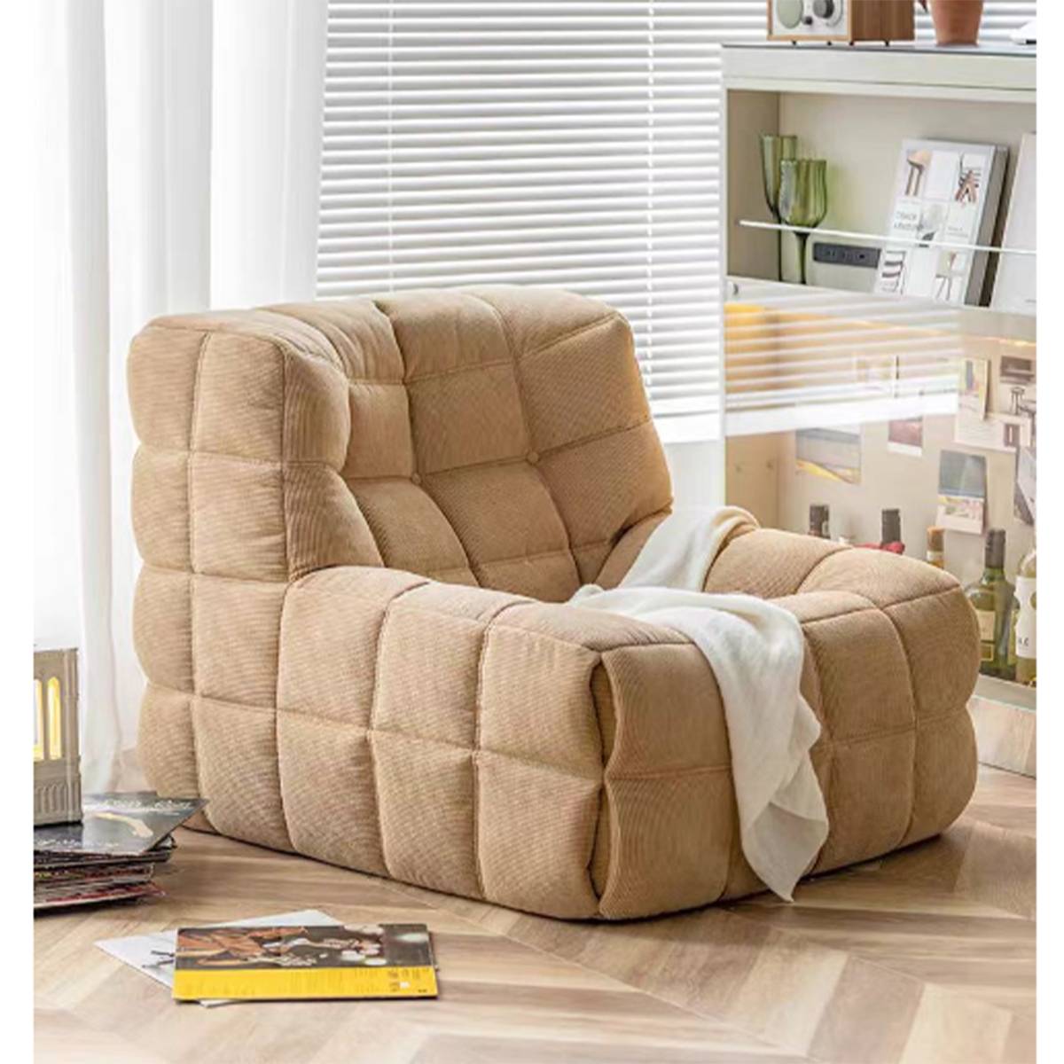 Beige waffle grid lounge chair with a white throw blanket