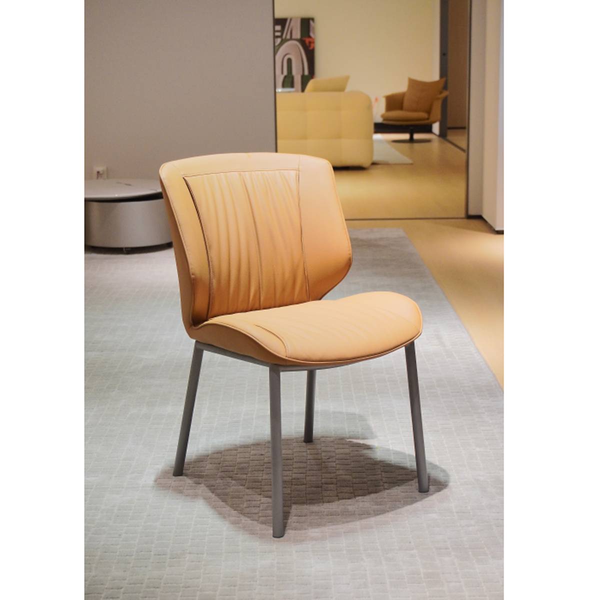 Yellow dining chair with carbon steel legs on a grey rug