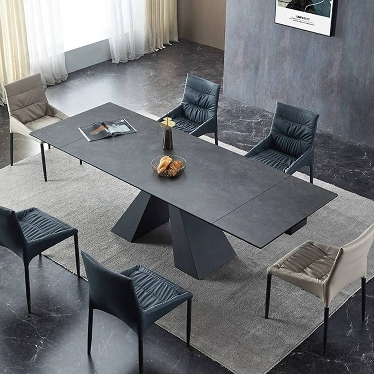 Side view of the extended black sintered stone dining table with a geometric base