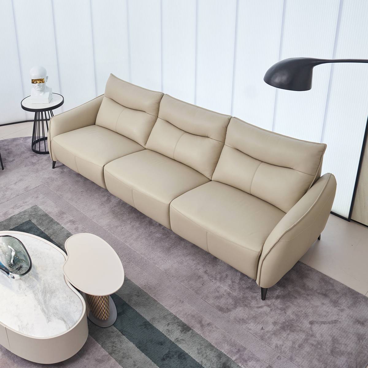 High-angle view of the beige leather sofa showing the seating depth and armrests