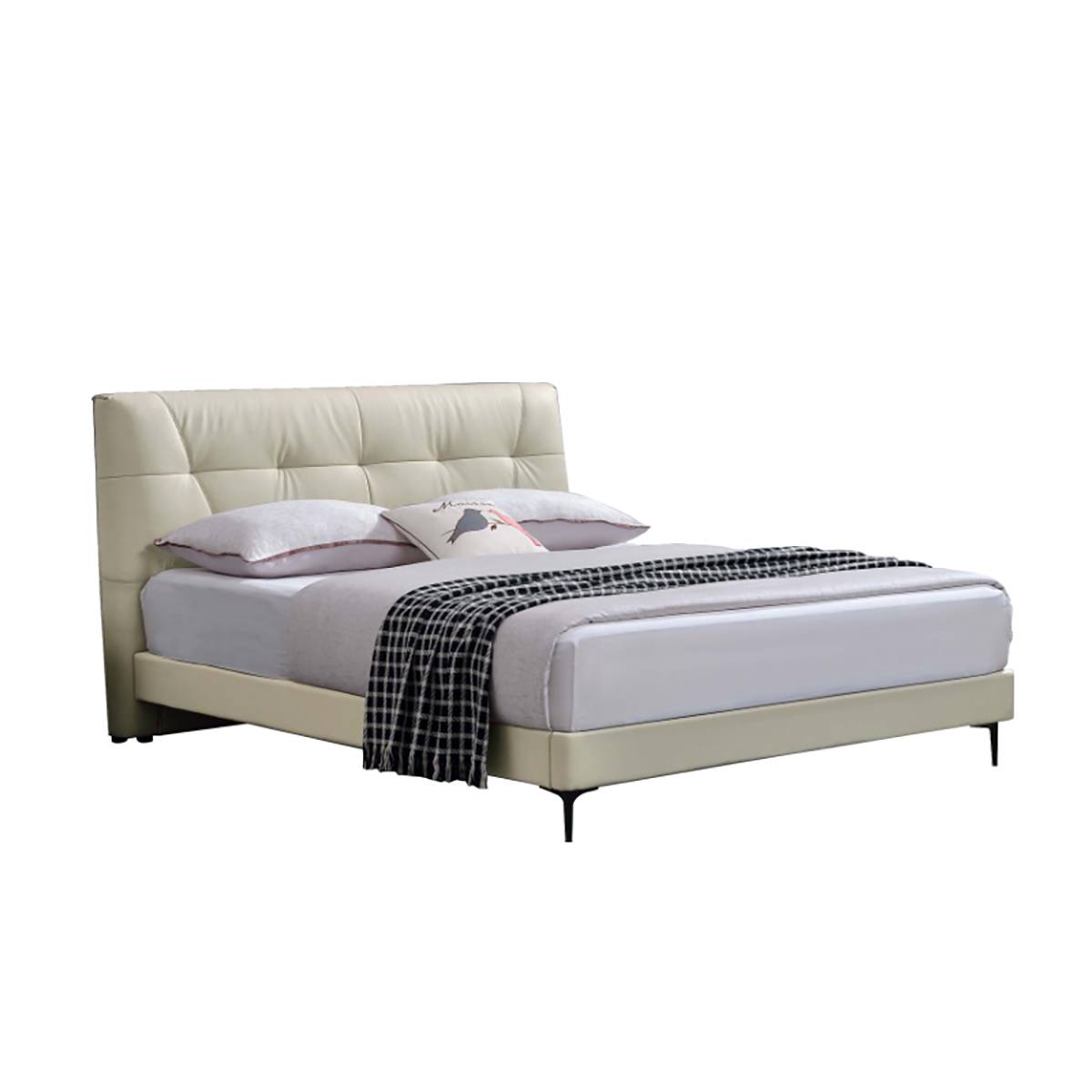 Side view of the cream-colored leather bed with a checkered throw blanket