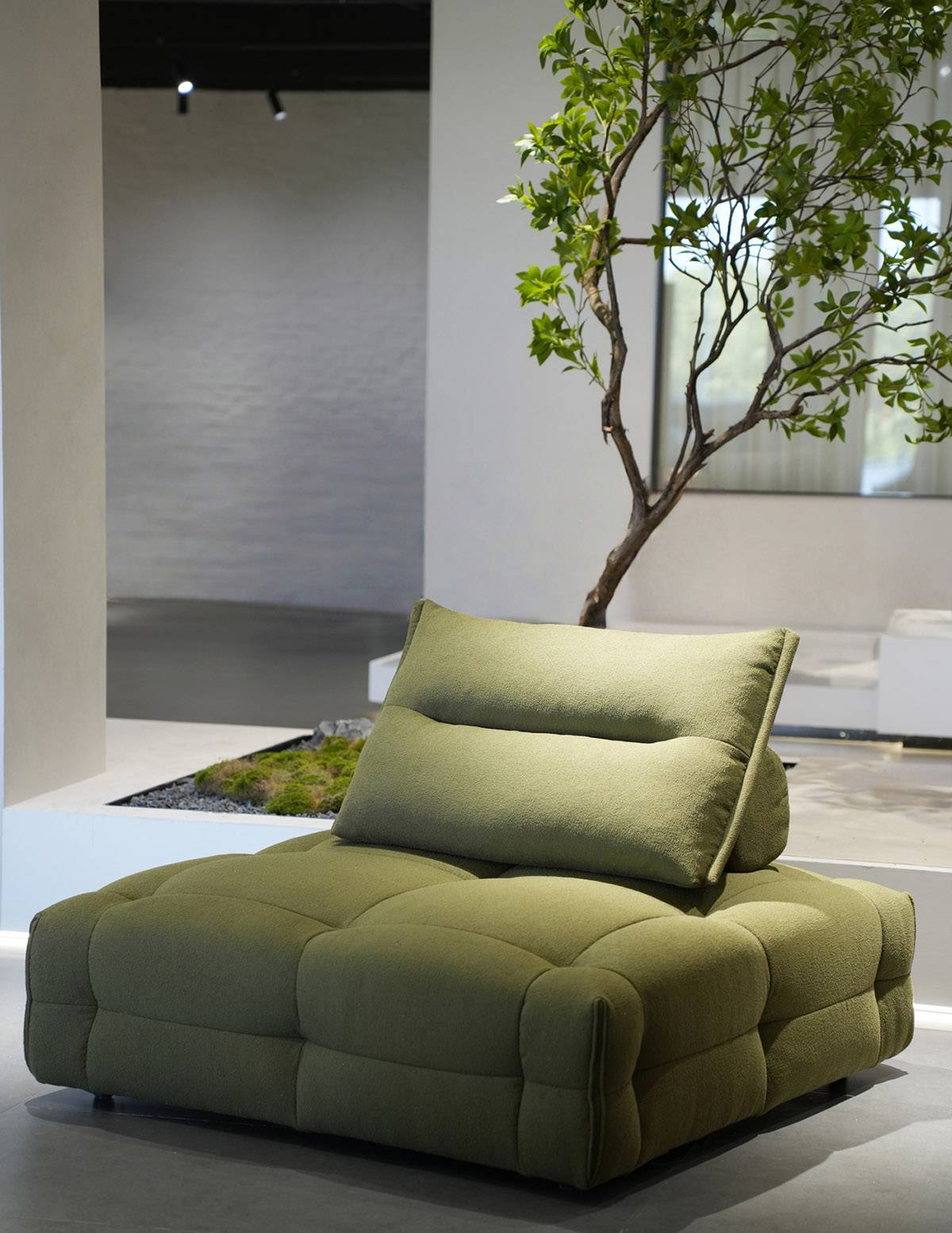 Full view of the green leisure sofa in a modern interior setting
