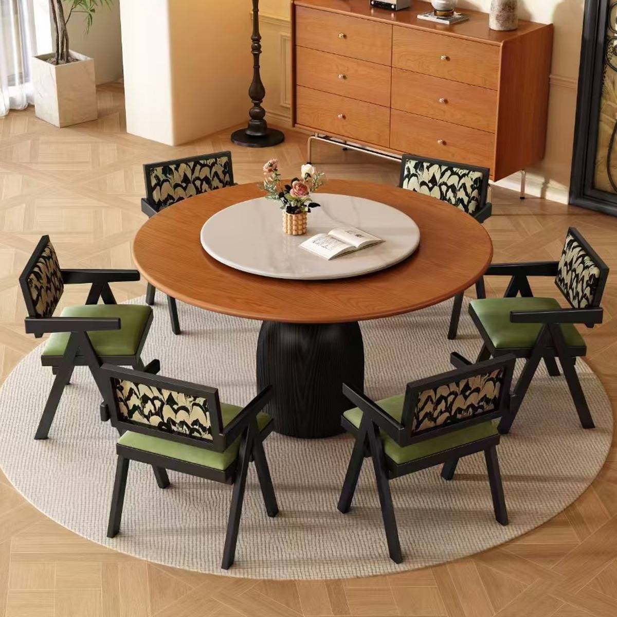 Walnut finish round dining table with a white turntable and green upholstered chairs.