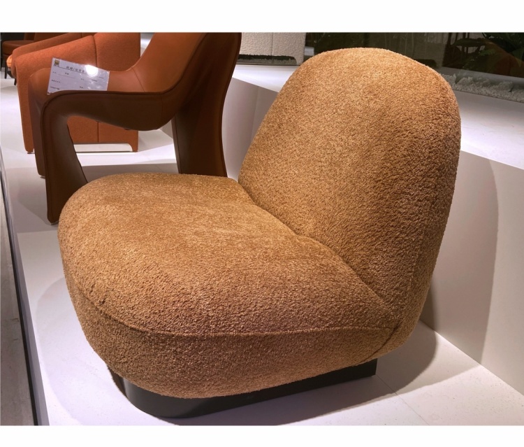 Side view of the lounge chair showing the rounded back and base
