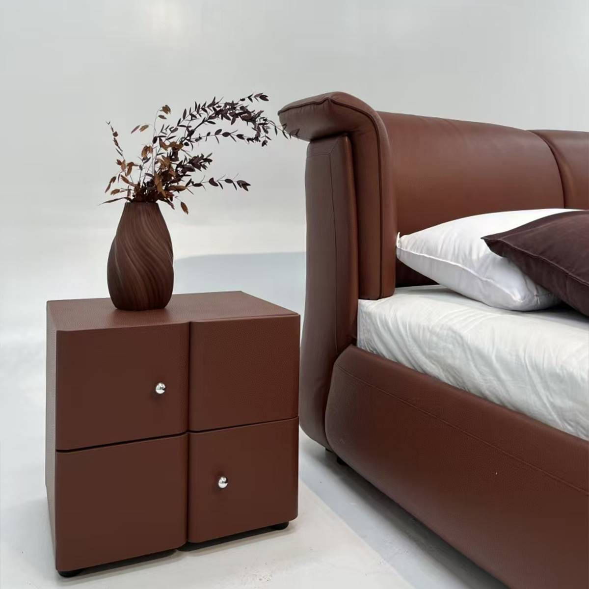Close-up detail of the leather texture on the bed frame and bedside table