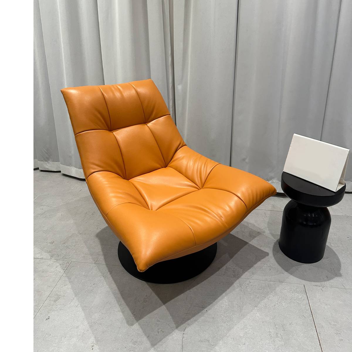 Side view of orange lounge chair in showroom setting