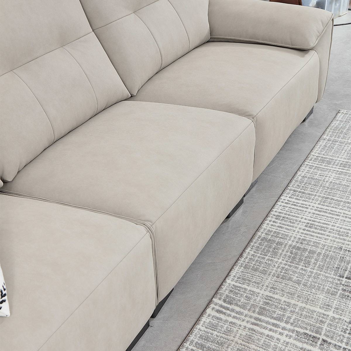 Close-up of the sofa seat cushions and backrest, showing the stitching and fabric material.