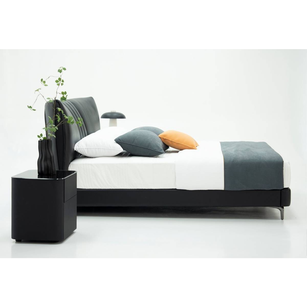 Side angle view of the bed showing the headboard and nightstand