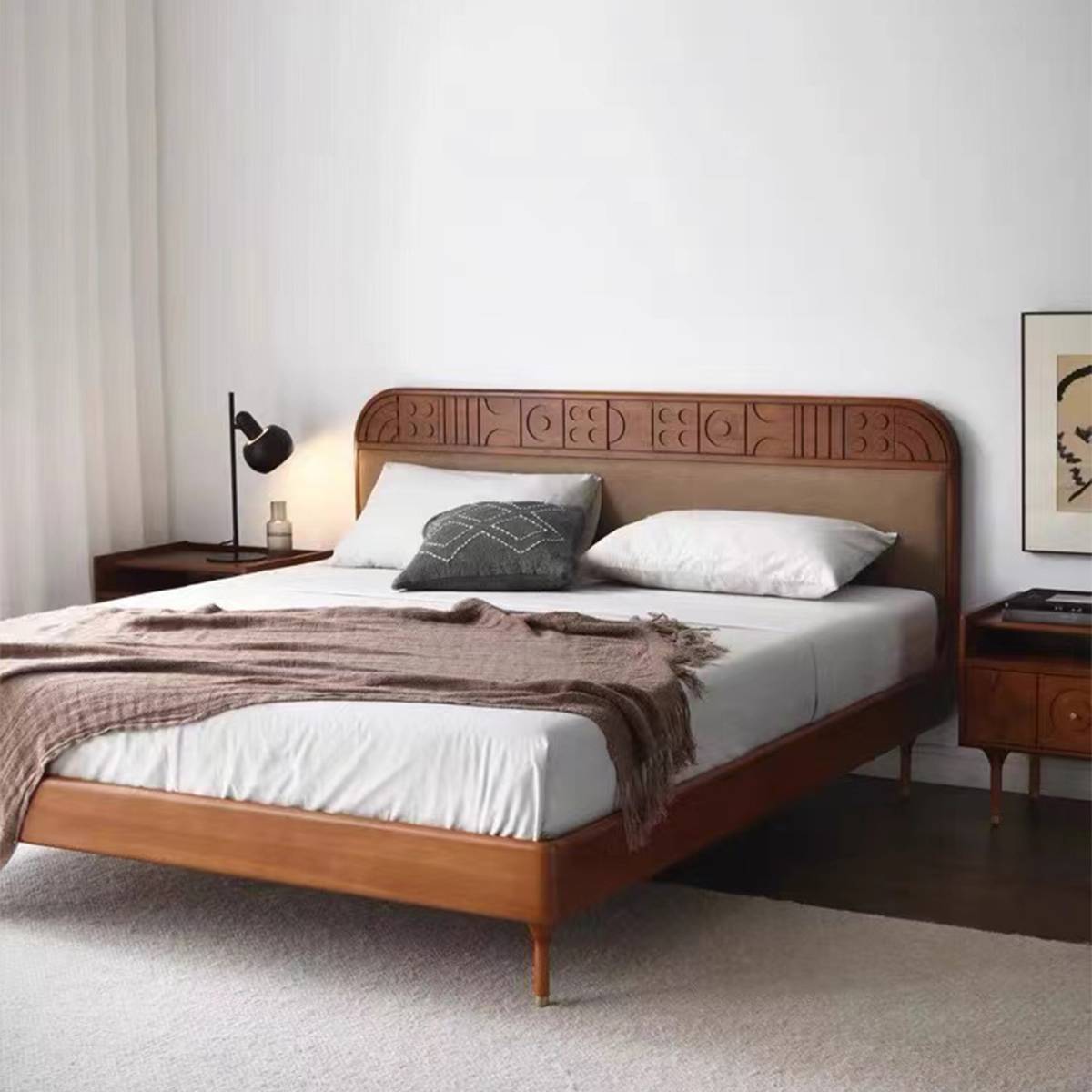 Full view of the mid-century solid wood bed with carved headboard and upholstered panel