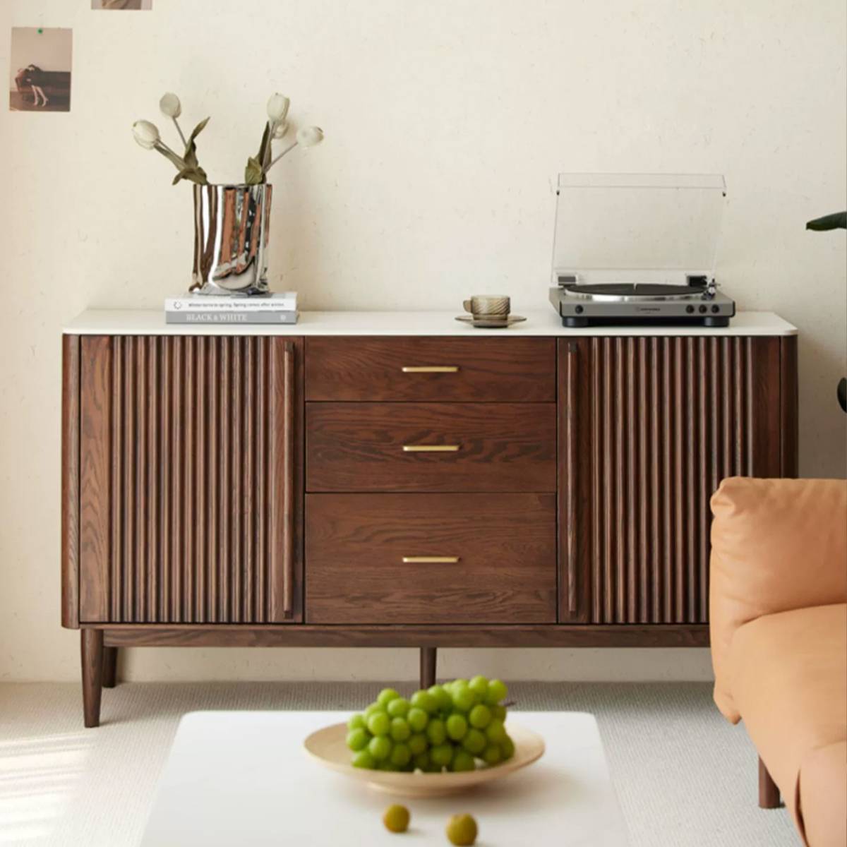 Lower cabinet section of the sideboard used as a media console with a record player