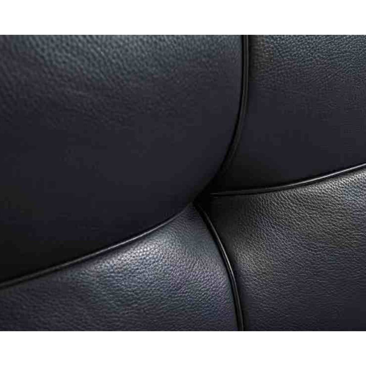 Macro shot of the black leather texture and stitching on the headboard