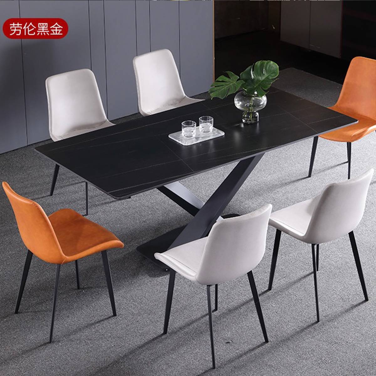 Black sintered stone dining table with white and orange chairs