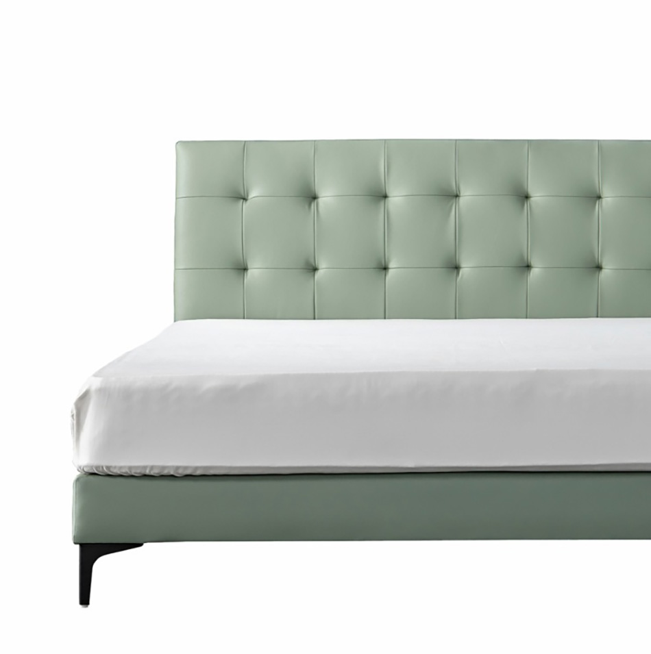 Close-up detail of the tufted leather headboard and mattress edge