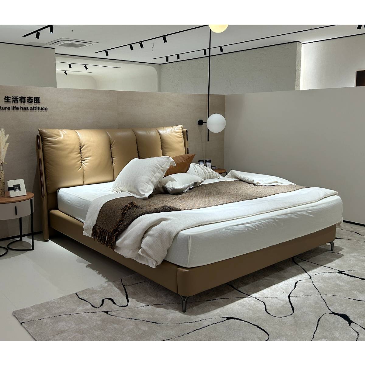Side view of the B22 leather bed in a showroom setting