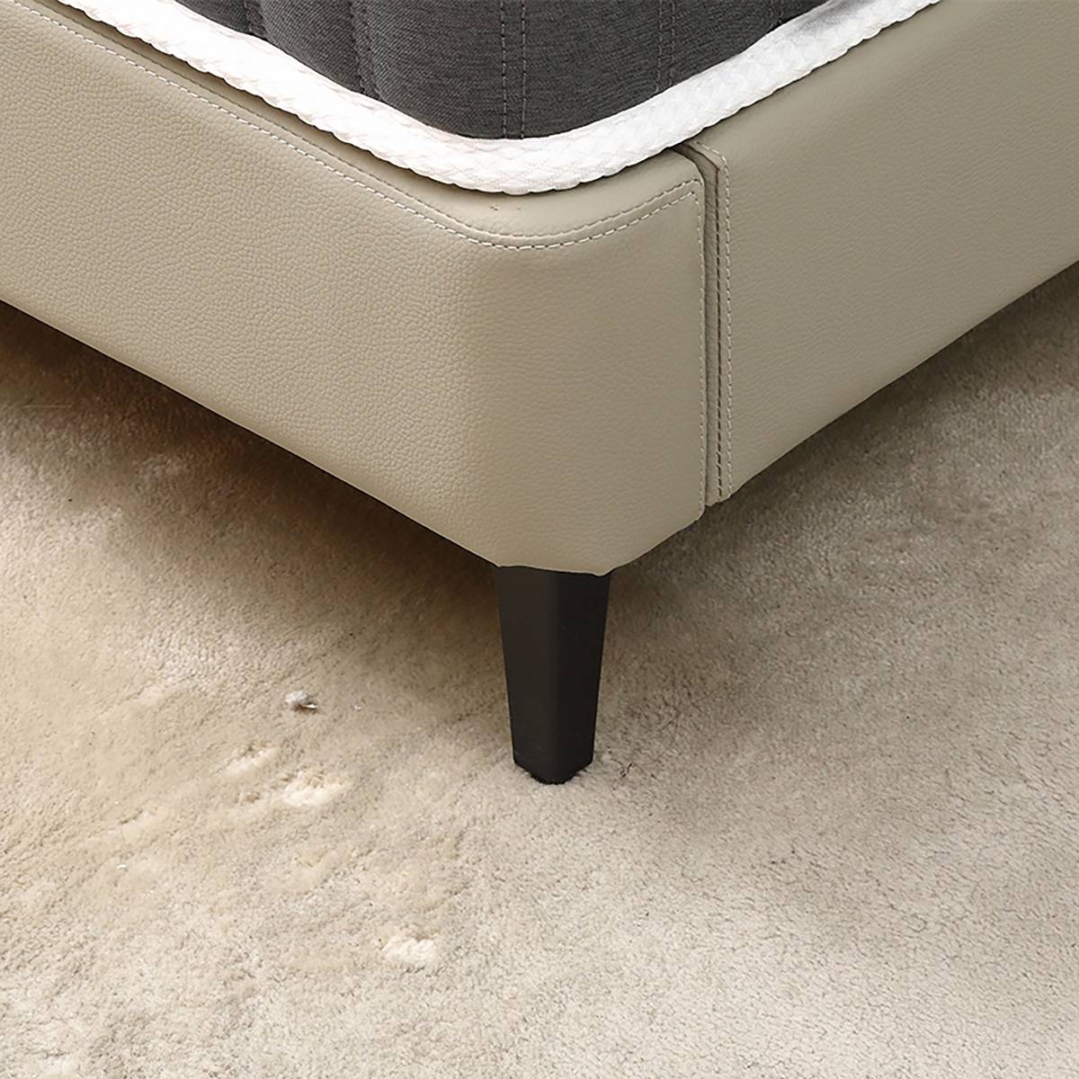 Detail shot of the bed frame corner and tapered leg.