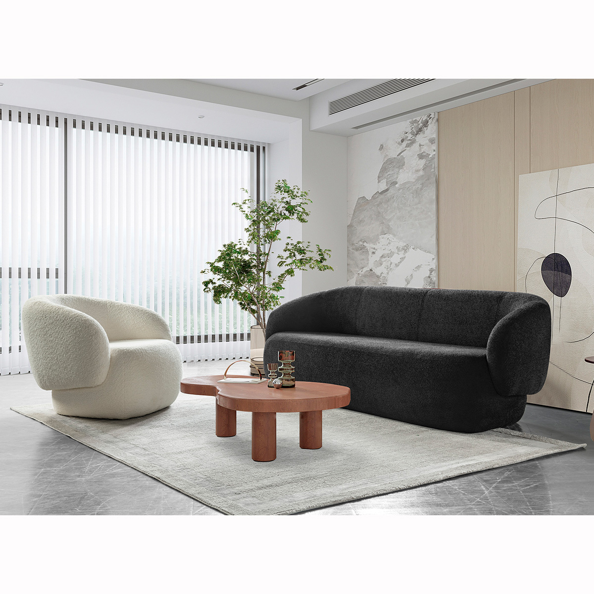 Lifestyle shot of the black sofa in a modern living room with a white armchair and wooden coffee table