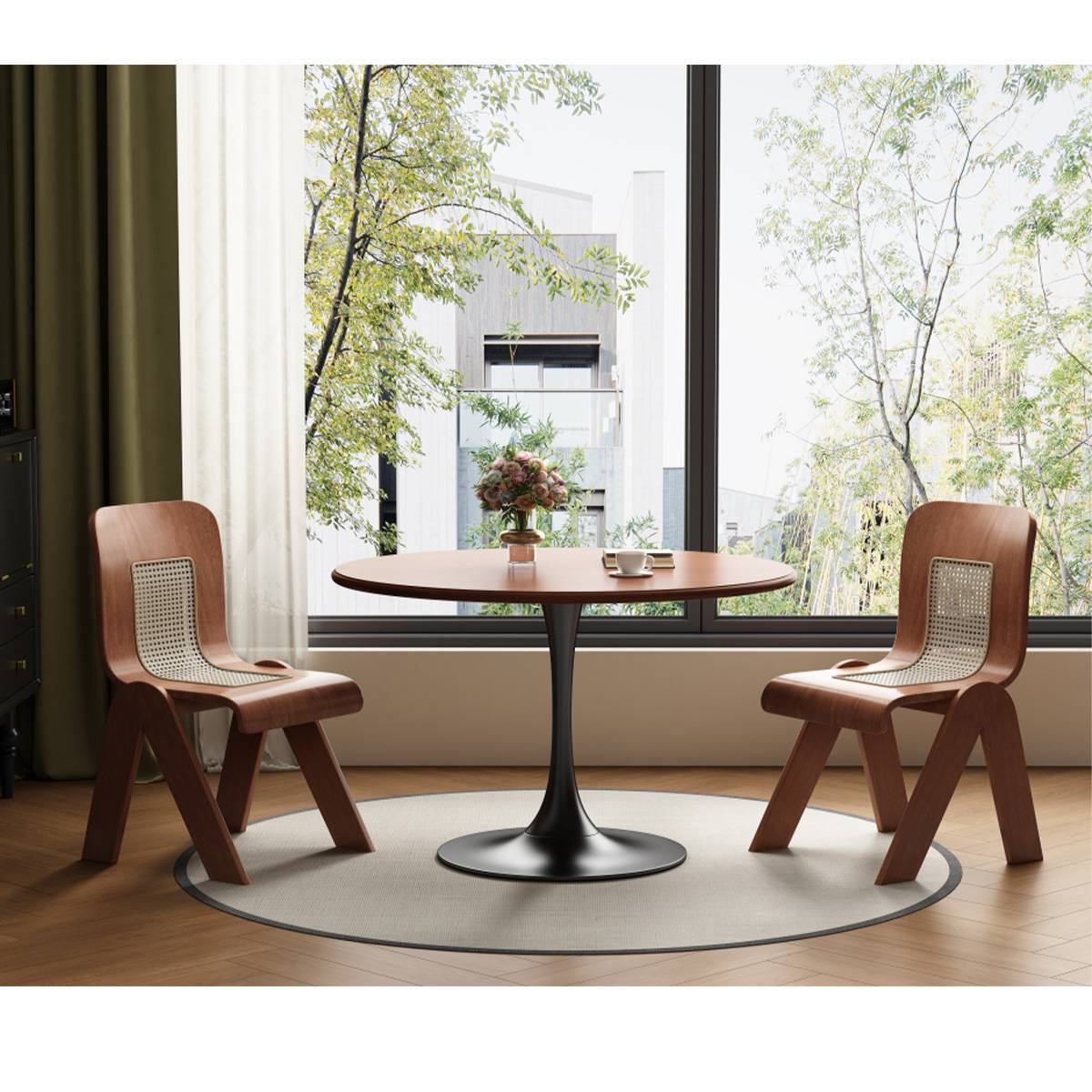 Round dining table with black tulip base and wooden cane chairs in a bright room