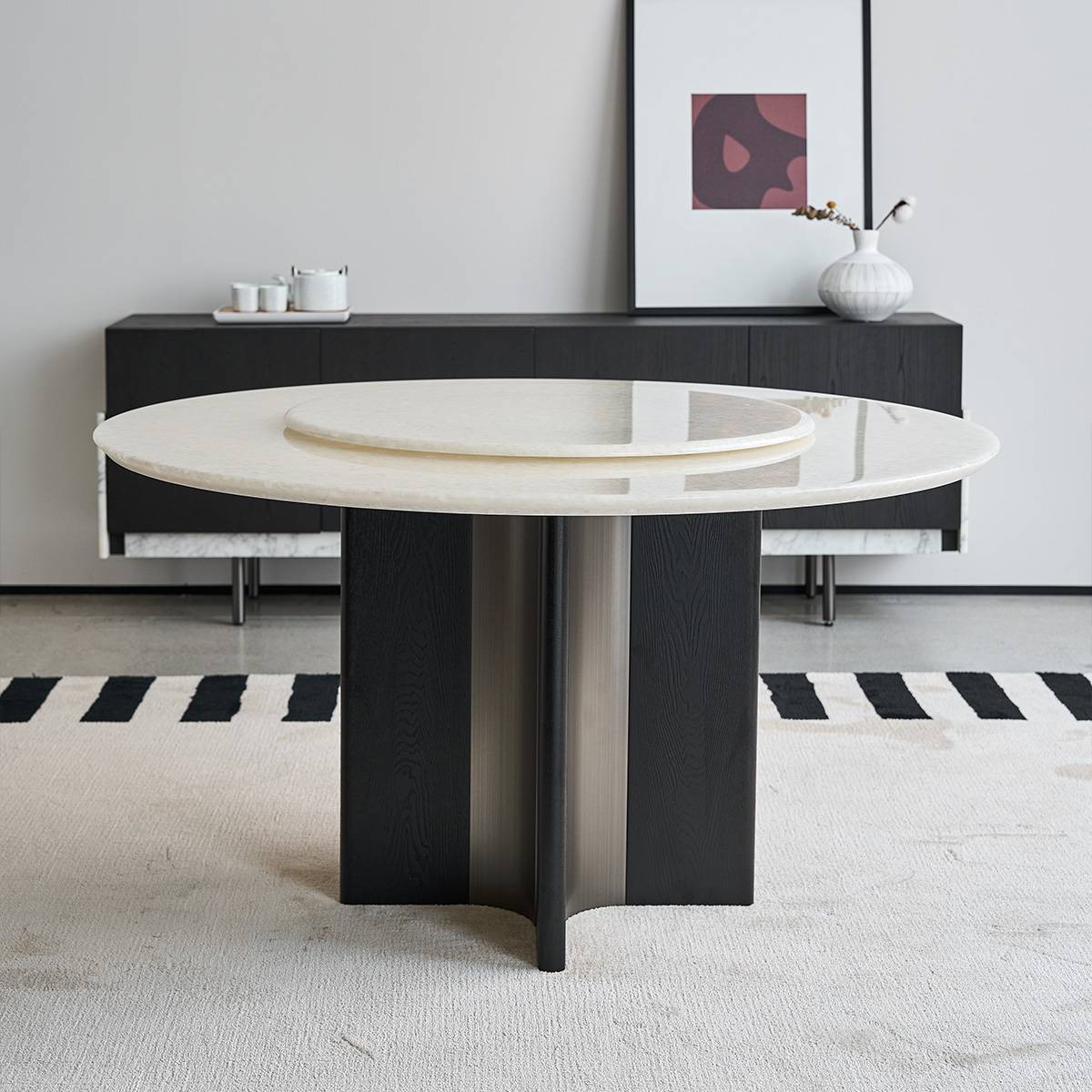 Close-up of the table base and edge, showing the contrast between the stone top and metal leg.