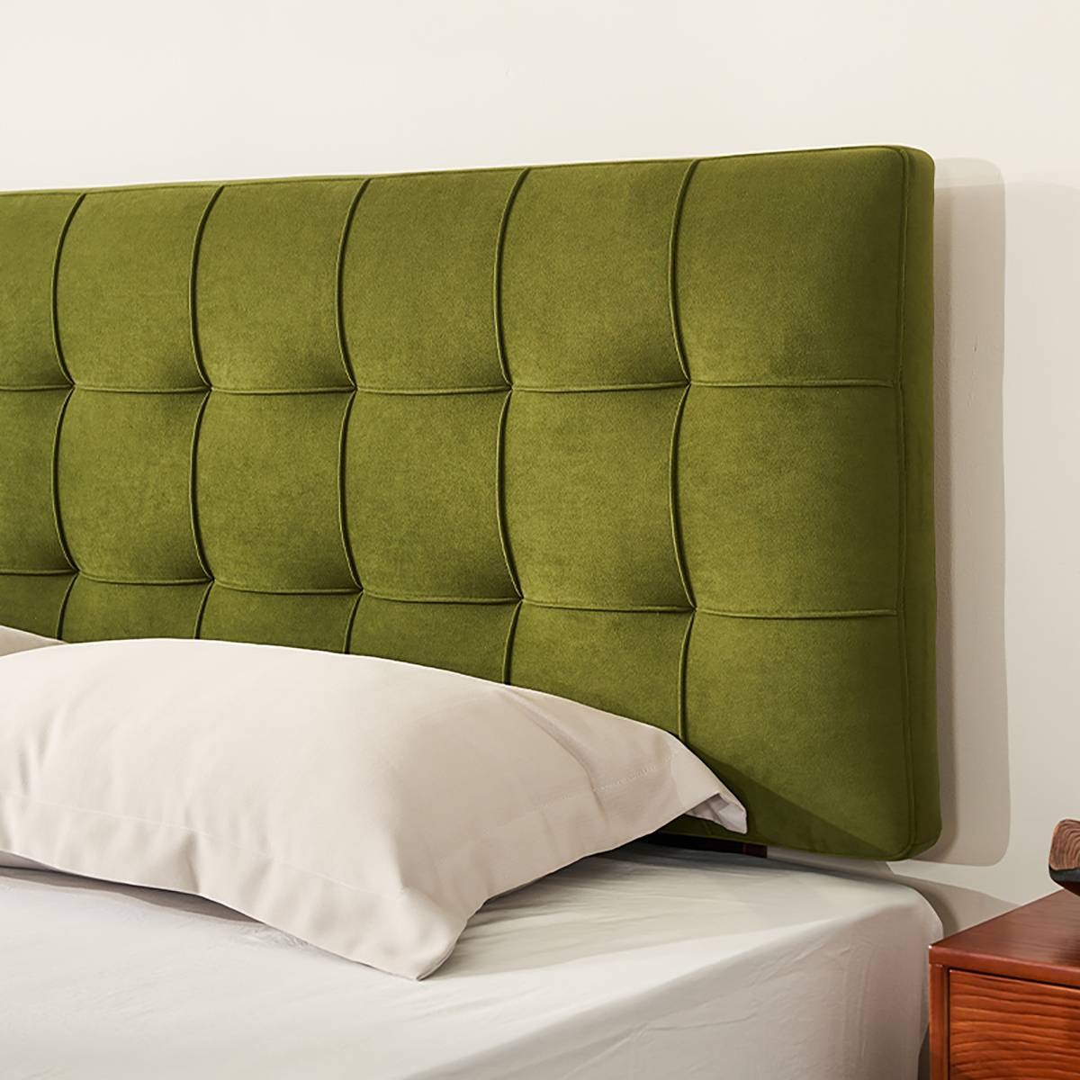 Close-up detail of the green velvet waffle tufted headboard