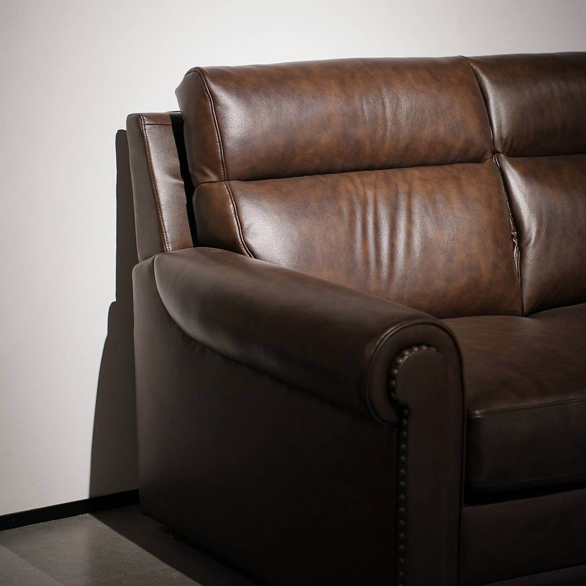 Side view of the sofa showing the rolled arm and back cushions