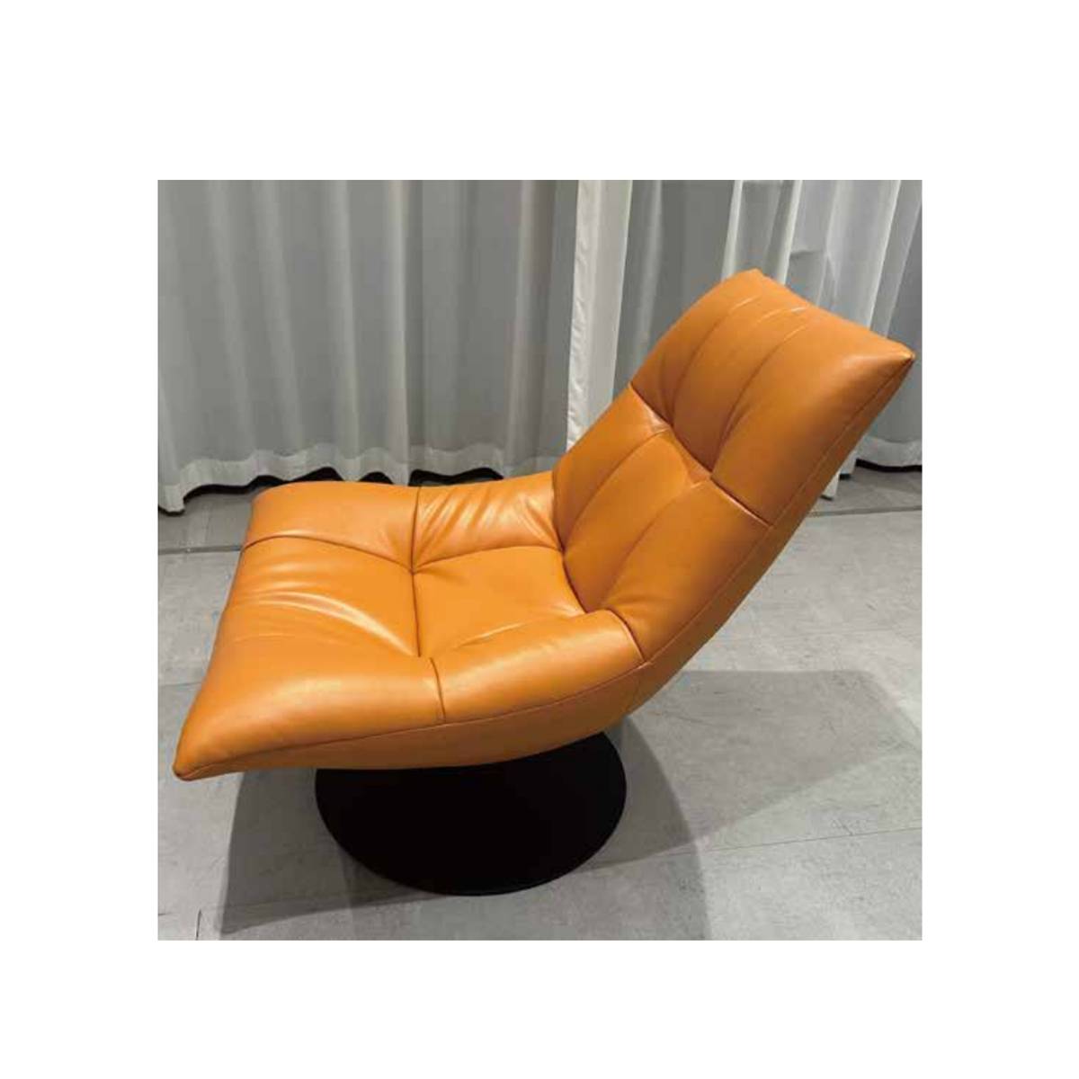 Angled view of orange lounge chair highlighting seat depth
